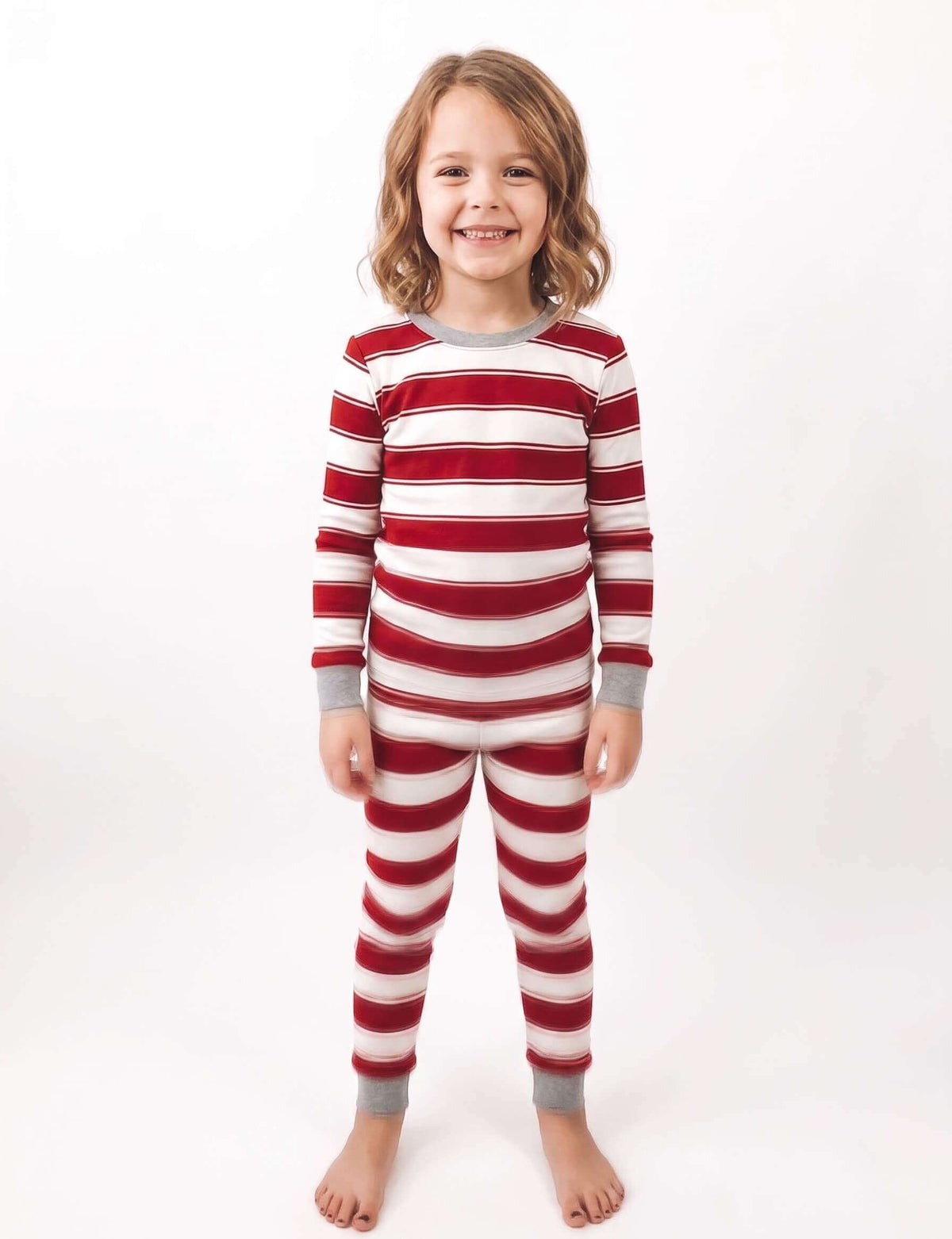 Family wearing matching red and white striped Christmas pajamas with gray trim - view 11