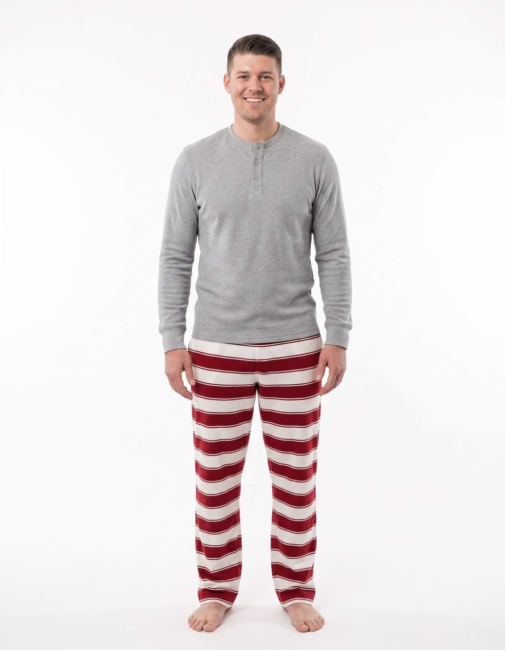 Family wearing matching red and white striped Christmas pajamas with gray trim - view 8