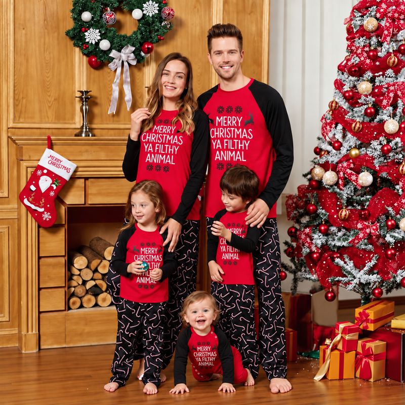 Family matching Christmas pajamas with red raglan slogan tops and black candy cane print pants