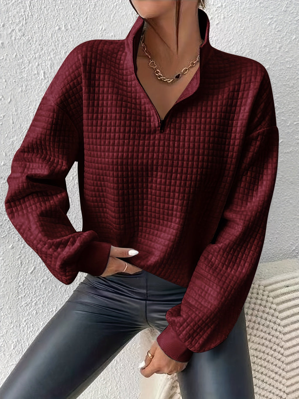 Woman wearing an oversized waffle knit quarter zip sweater with stand collar and ribbed cuffs - view 18