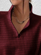 Woman wearing an oversized waffle knit quarter zip sweater with stand collar and ribbed cuffs - view 20