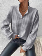 Woman wearing an oversized waffle knit quarter zip sweater with stand collar and ribbed cuffs - view 22