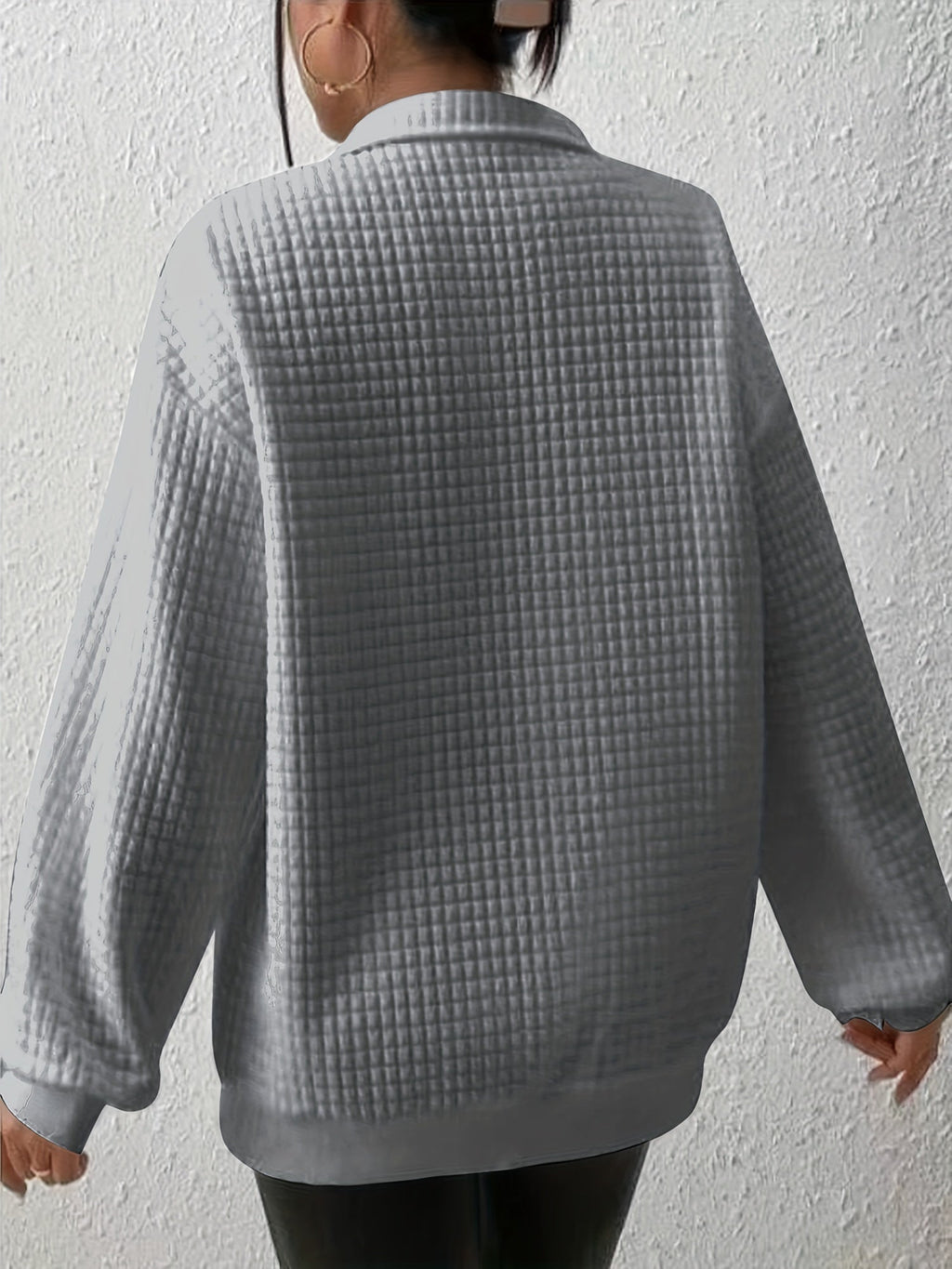 Woman wearing an oversized waffle knit quarter zip sweater with stand collar and ribbed cuffs - view 23