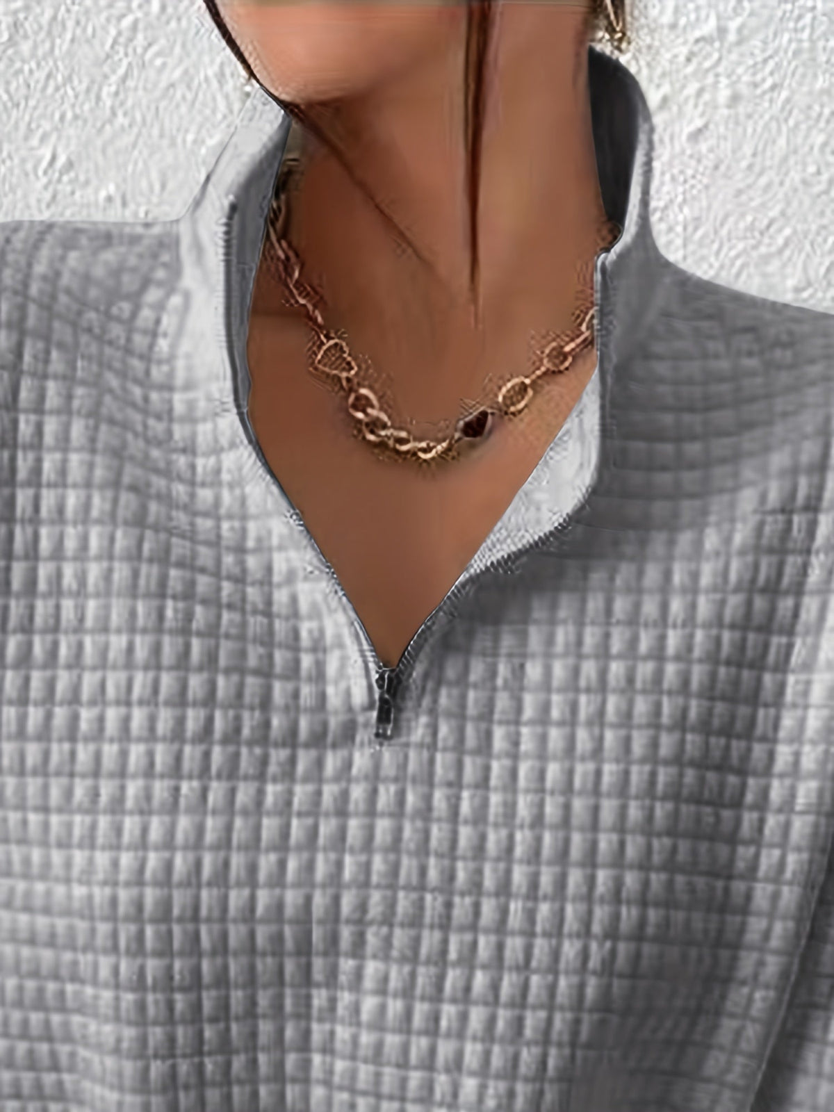 Woman wearing an oversized waffle knit quarter zip sweater with stand collar and ribbed cuffs - view 24