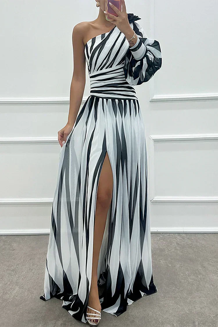 Woman wearing a striped one-shoulder maxi dress with balloon sleeve, ruched waist and high slit