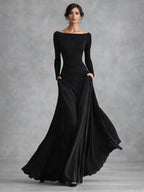Black boat neck long sleeve maxi dress with draped waist and flowing skirt