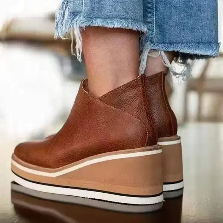 Women's brown leather-look wedge ankle boots with striped platform sole and side zip