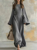 Long sleeve wedding guest dress with flared bell sleeves and floor-length hem
