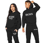 Matching hoodie and jogger tracksuit set with white slogan print, worn as a couple - view 2