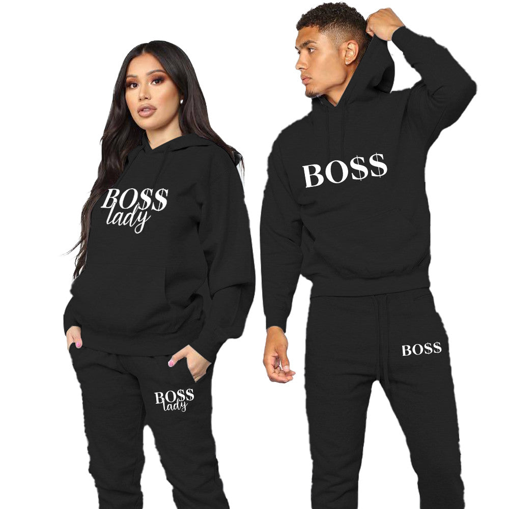 Matching hoodie and jogger tracksuit set with white slogan print, worn as a couple - view 2