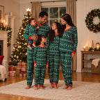 Matching family Christmas pajamas in green with white tree print and red cuffs