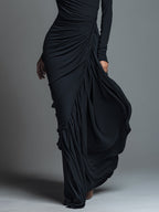 Model in a black formal evening maxi dress with long sleeves and draped skirt - view 3