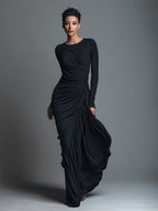Model in a black formal evening maxi dress with long sleeves and draped skirt - view 4