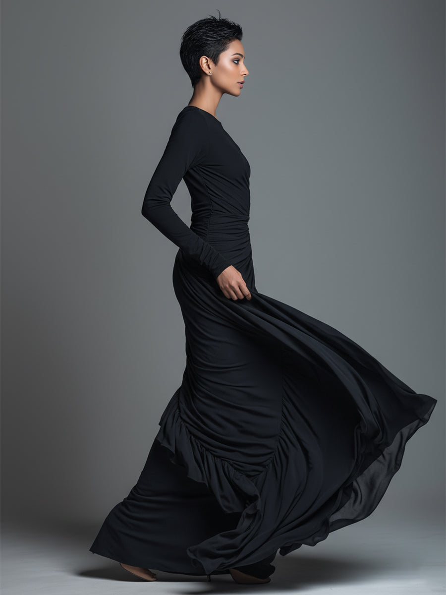Model in a black formal evening maxi dress with long sleeves and draped skirt - view 5