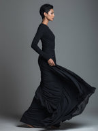 Model in a black formal evening maxi dress with long sleeves and draped skirt - view 5