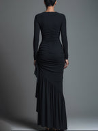Model in a black formal evening maxi dress with long sleeves and draped skirt - view 6