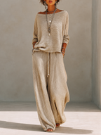 Model in a slouchy khaki knit sweater set with wide leg drawstring pants