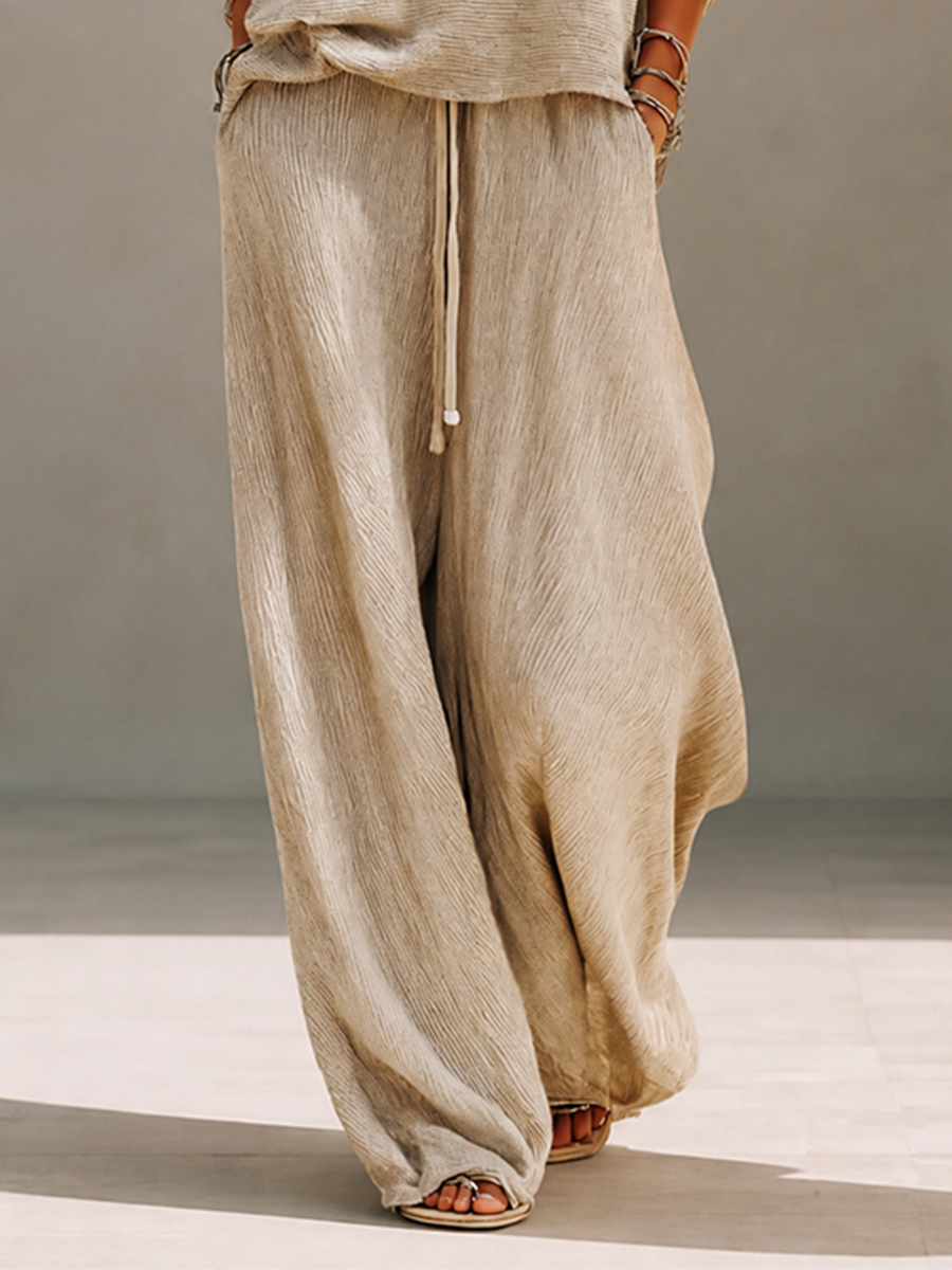Model in a slouchy khaki knit sweater set with wide leg drawstring pants - view 7