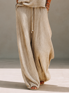 Model in a slouchy khaki knit sweater set with wide leg drawstring pants - view 7