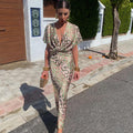Green and pink animal print satin dress with twist front V-neck and flutter sleeves