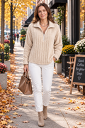 Woman wearing a ribbed plush quarter zip sweater with white jeans and ankle boots