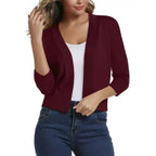 Woman wearing a cropped open front cardigan with 3/4 sleeves over a white tank and jeans - view 17