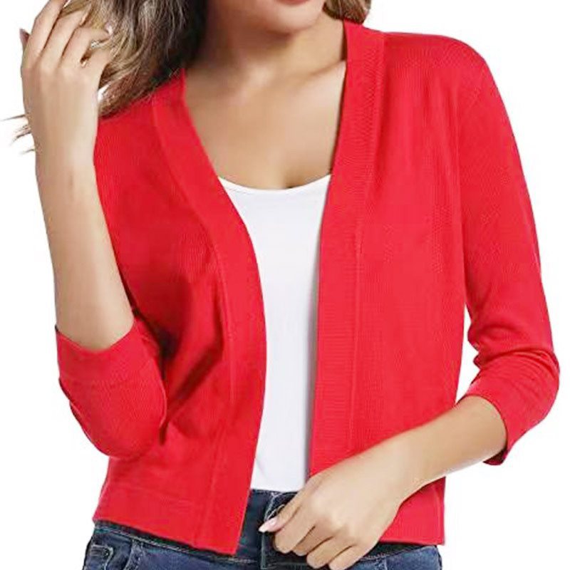 Woman wearing a cropped open front cardigan with 3/4 sleeves over a white tank and jeans - view 18