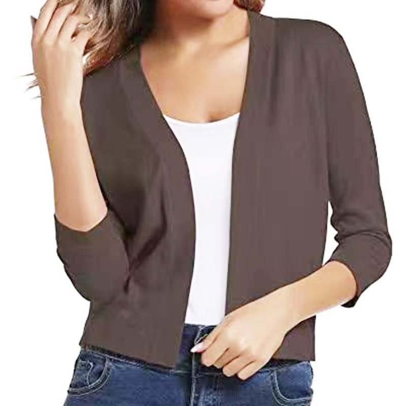 Woman wearing a cropped open front cardigan with 3/4 sleeves over a white tank and jeans - view 19