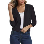 Woman wearing a cropped open front cardigan with 3/4 sleeves over a white tank and jeans - view 3