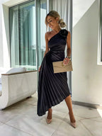 Woman wearing a one-shoulder pleated satin midi dress with a shoulder rosette, waist cutout and asymmetric hem - view 10