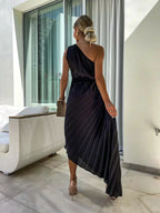 Woman wearing a one-shoulder pleated satin midi dress with a shoulder rosette, waist cutout and asymmetric hem - view 12