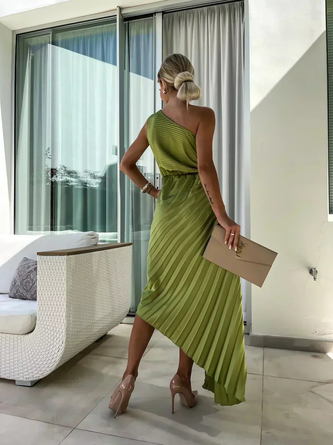 Woman wearing a one-shoulder pleated satin midi dress with a shoulder rosette, waist cutout and asymmetric hem - view 9